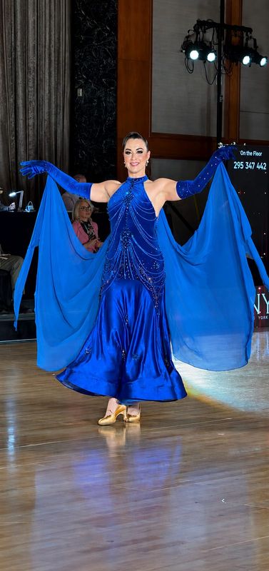 Royal-blue draped gown with cape sleeves