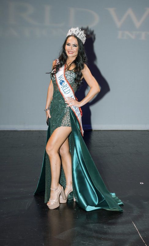 Emerald-green sequin gown with train and crown
