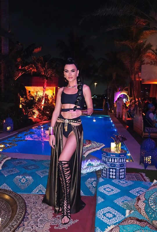 Black and gold cut-out gown by the pool